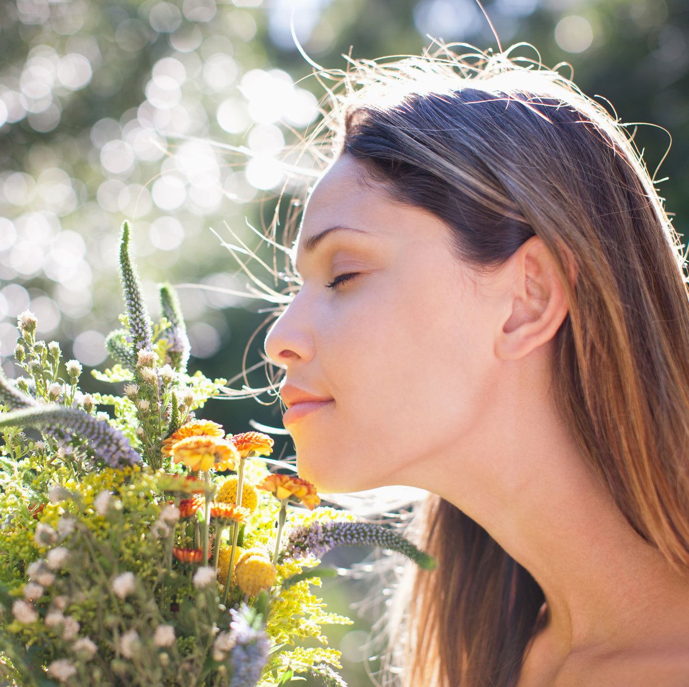 woman smelling ethically sourced and natural wildflowers